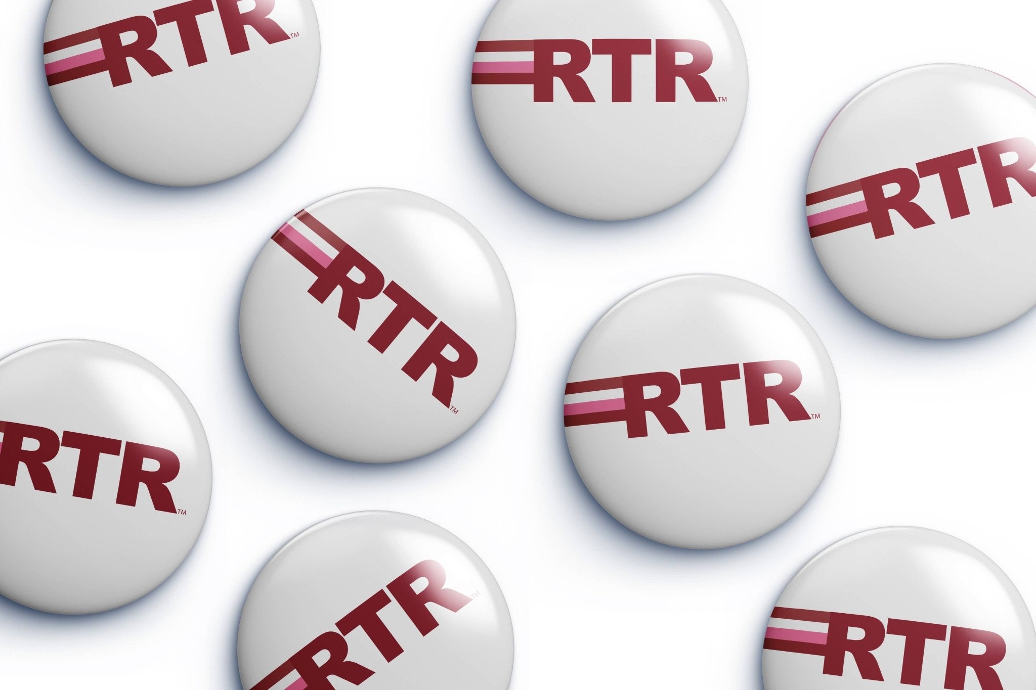 Multiple white oval buttons with the red 'RTR' logo scattered on a white background.