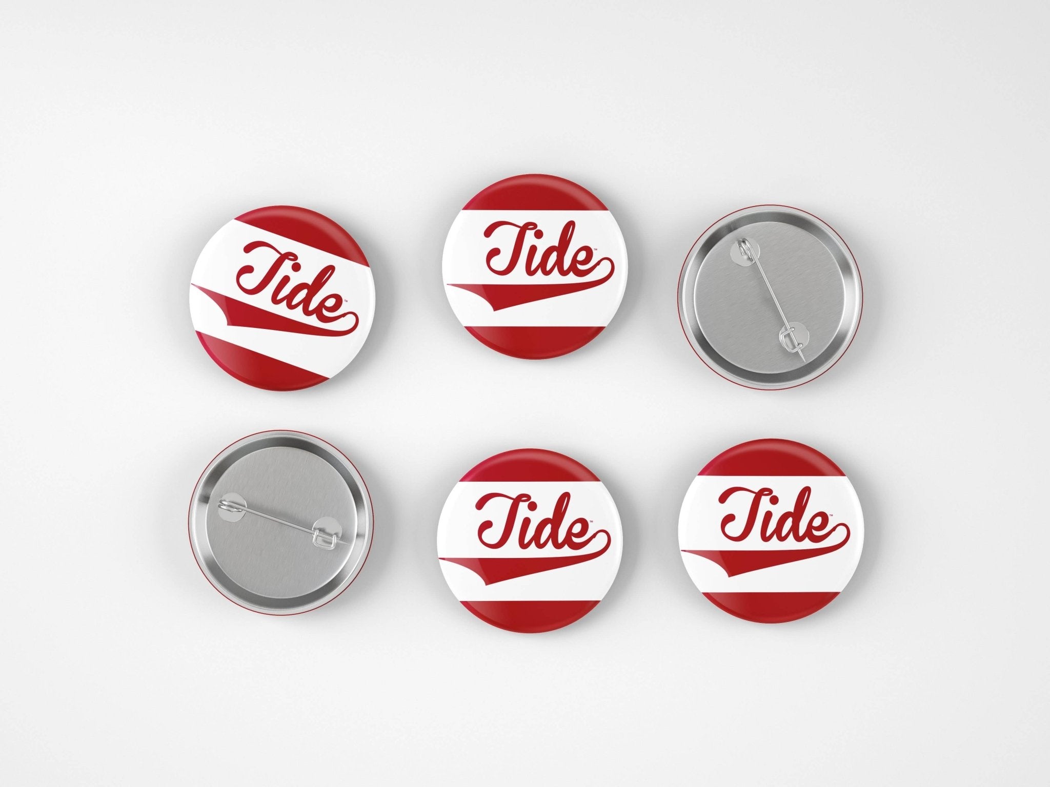 Six round pin-back buttons with a red and white striped design and the word 'Tide' in red script, shown on a light gray background with two front views and two back views.