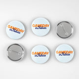 Six round pin-back buttons shown on a light gray background, including three front views and three back views. The front buttons have a white background with orange and blue text reading 'GAMEDAY in Auburn'.