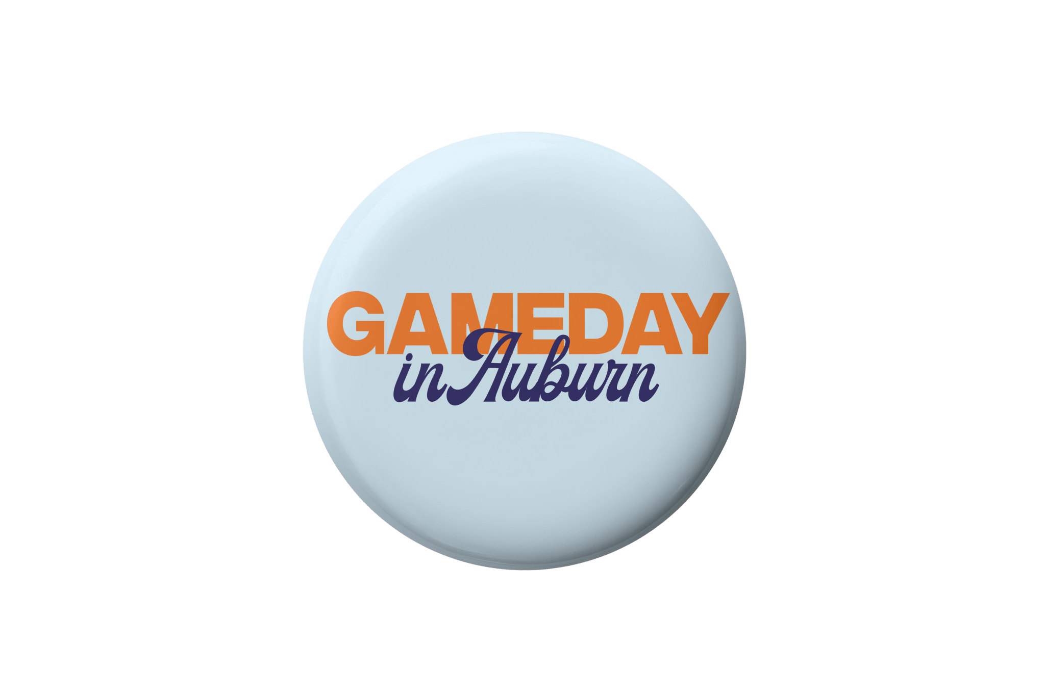 A round light blue button badge featuring the text 'GAMEDAY in Auburn' in orange and navy blue lettering, centered on a plain white background.