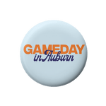 A round light blue button badge featuring the text 'GAMEDAY in Auburn' in orange and navy blue lettering, centered on a plain white background.