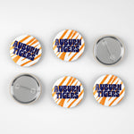 Six round pin-back buttons with Auburn Tigers branding, showing both front and back views on a light gray background.