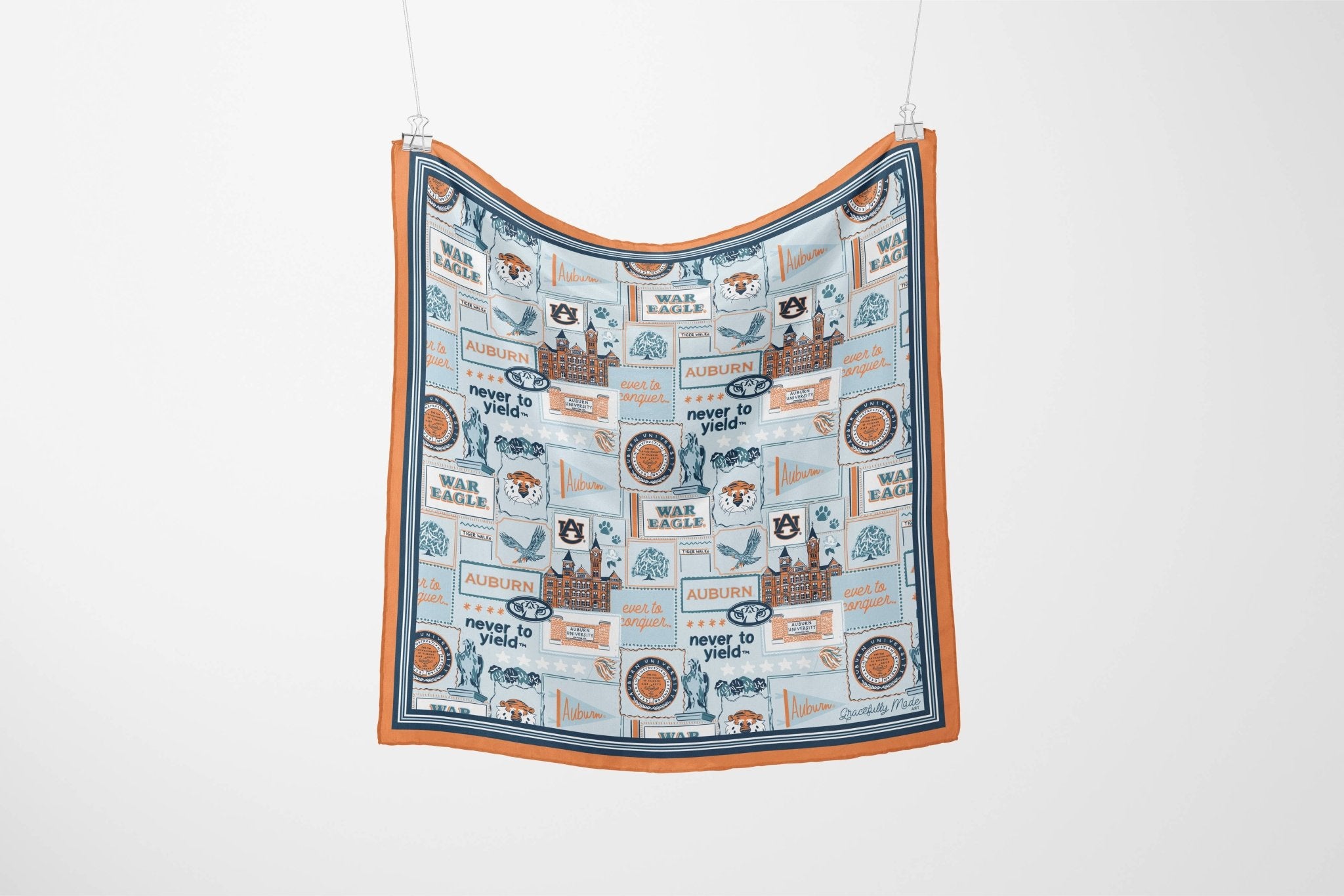 Fabric with vintage-style illustrations and text hanging on a white background