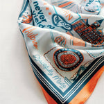 Decorative scarf with text and graphics on a white background