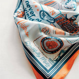 Decorative scarf with text and graphics on a white background