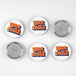 Six round pin-back buttons on a light gray background, showing both the front and back views. The front buttons feature the words 'WAR EAGLE' in orange with a blue outline, while the back buttons show the silver metal pin mechanism.