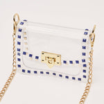 White handbag with gold chain and blue accents on a white background