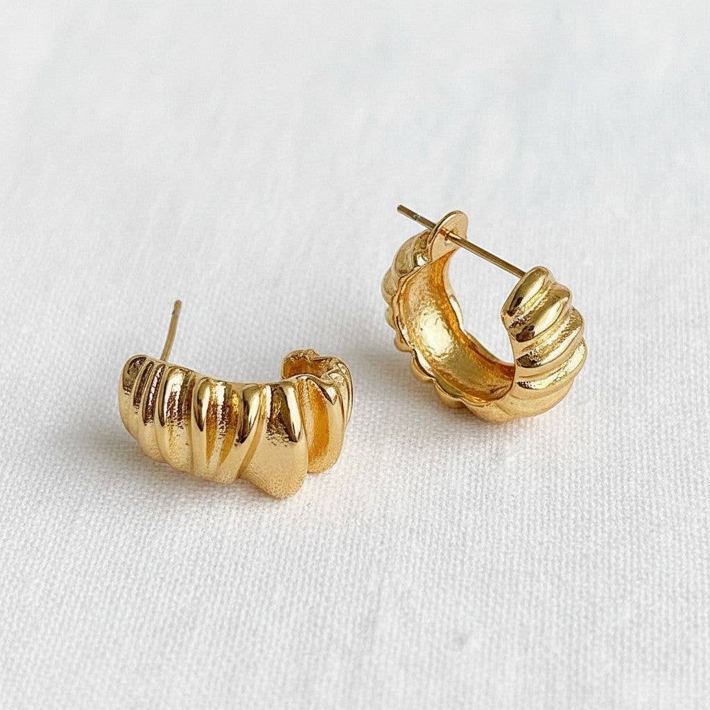 Gold hoop earrings on a white background