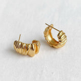 Gold hoop earrings on a white background