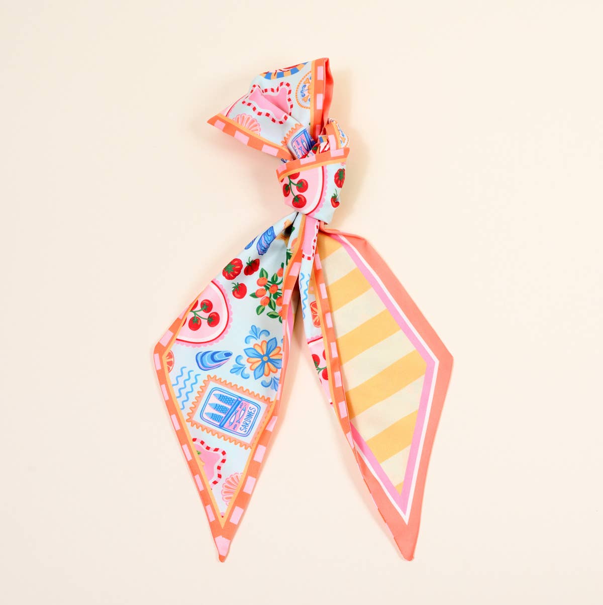 Colorful patterned hair bow on a light beige background