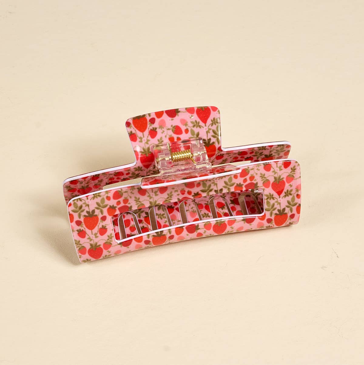 Hair clip with strawberry pattern on a beige background