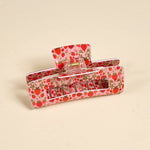 Hair clip with strawberry pattern on a beige background