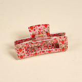 Hair clip with strawberry pattern on a beige background