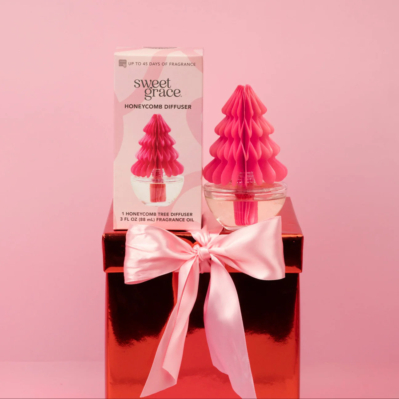 Sweet Grace honeycomb diffuser with packaging on a pink background