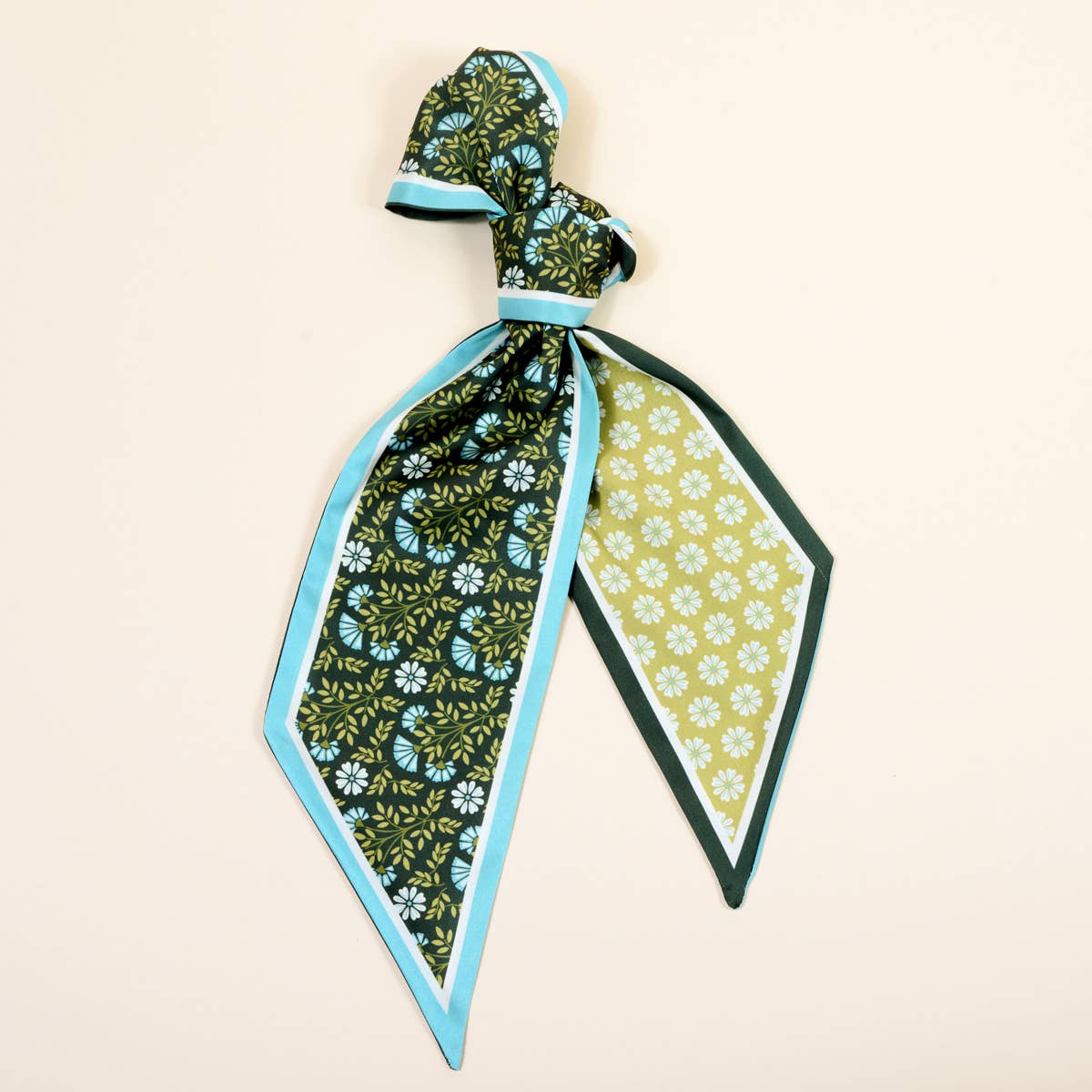 Two patterned scarves with floral designs on a beige background