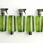 Five green spray bottles with black nozzles on a white background