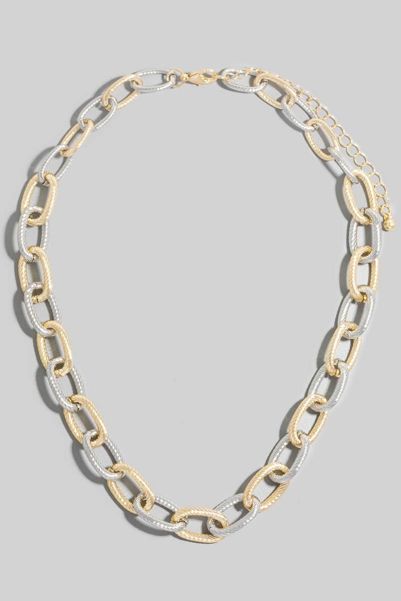Two-tone chain necklace on a gray background