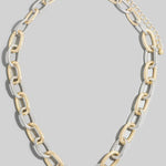 Two-tone chain necklace on a gray background