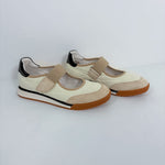 A pair of women's casual Mary Jane-style shoes in cream and beige, featuring a hook-and-loop strap, black heel accents, and brown soles, photographed on a light gray studio background.