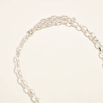 Silver chain bracelet on a light beige background