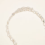 Silver chain bracelet on a light beige background