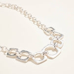 Silver chain bracelet on a light beige background