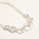 Silver chain bracelet on a light beige background