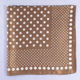 Brown square scarf with white polka dot pattern on a light gray background