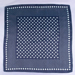 Navy blue square scarf with white polka dots on a white background