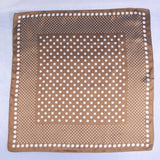 Brown fabric with white polka dot pattern on a white background