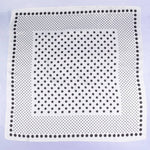 White square with black dot pattern on a light purple background