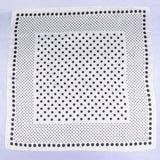 White square with black dot pattern on a light purple background
