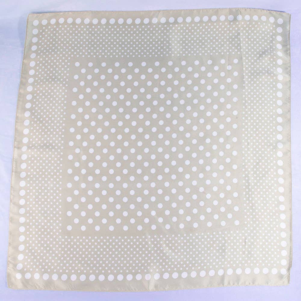 Beige fabric square with white polka dots on a light purple background