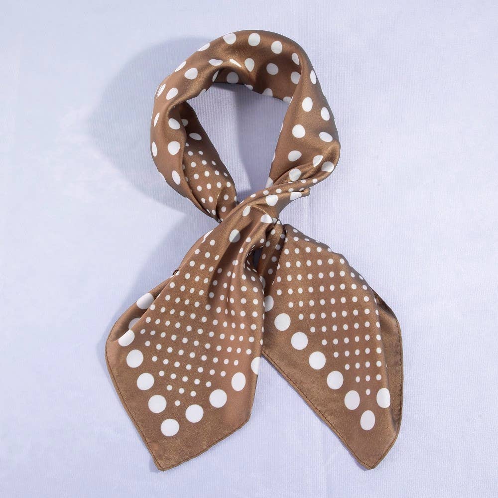 Brown scarf with white polka dot pattern on a light purple background