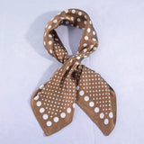 Brown scarf with white polka dot pattern on a light purple background