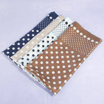 Four fabric swatches with polka dot patterns on a light purple background