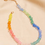 Necklace with multicolored beads on a beige fabric background