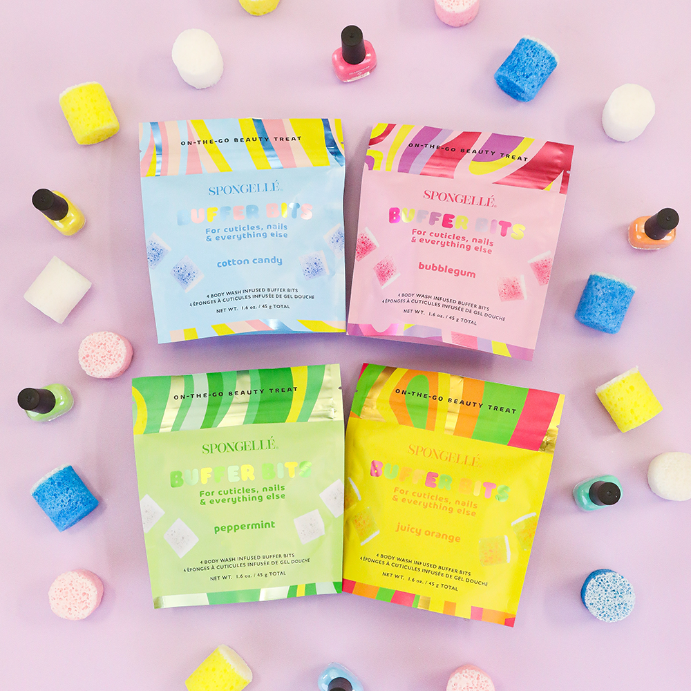 Colorful boxes of Swoogles beauty treats on a pink background with nail polish and candy.