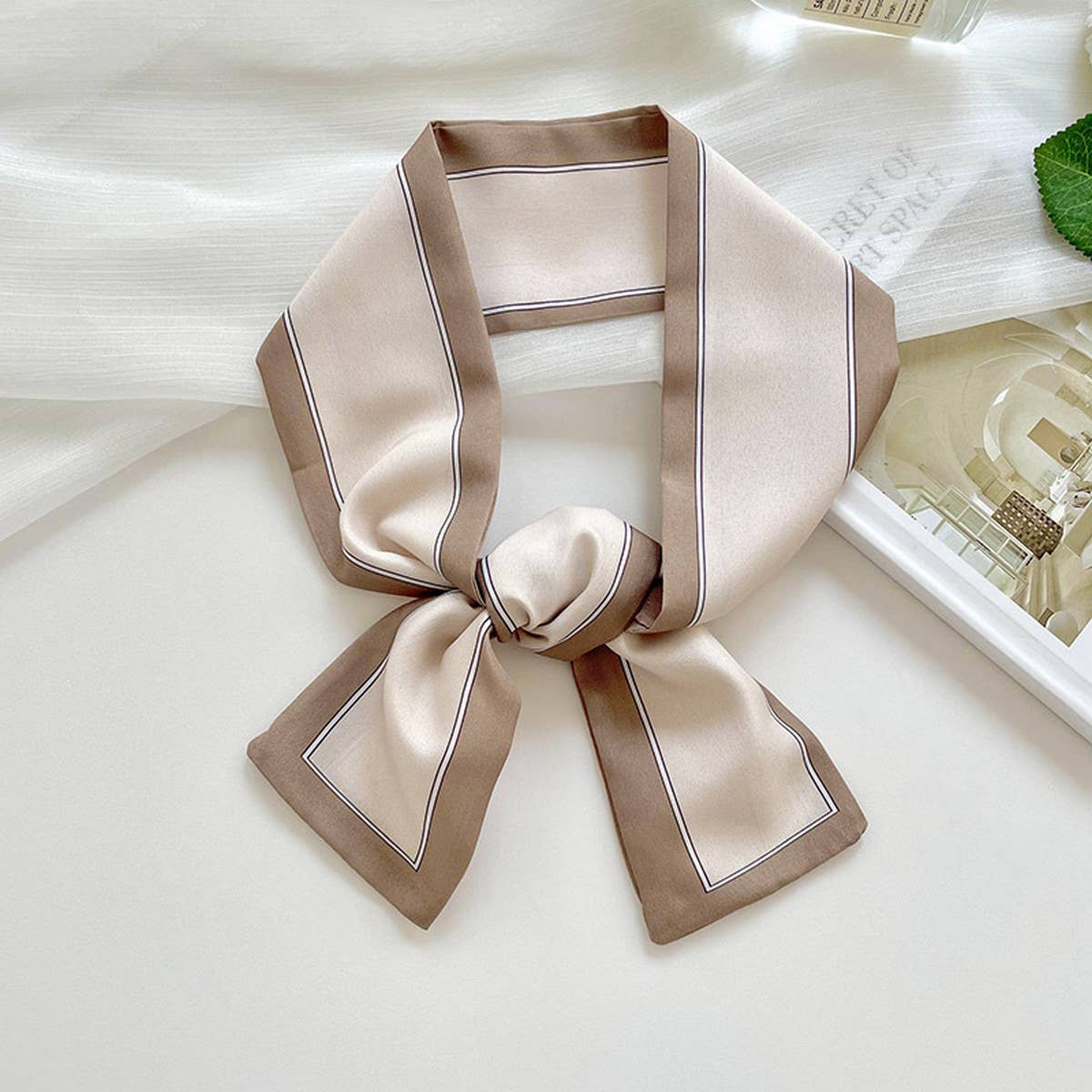 A collection of long decorative silk scarf headbands in various colors including purple, yellow, orange, black, and green.