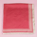 Red polka dot fabric on a pink background