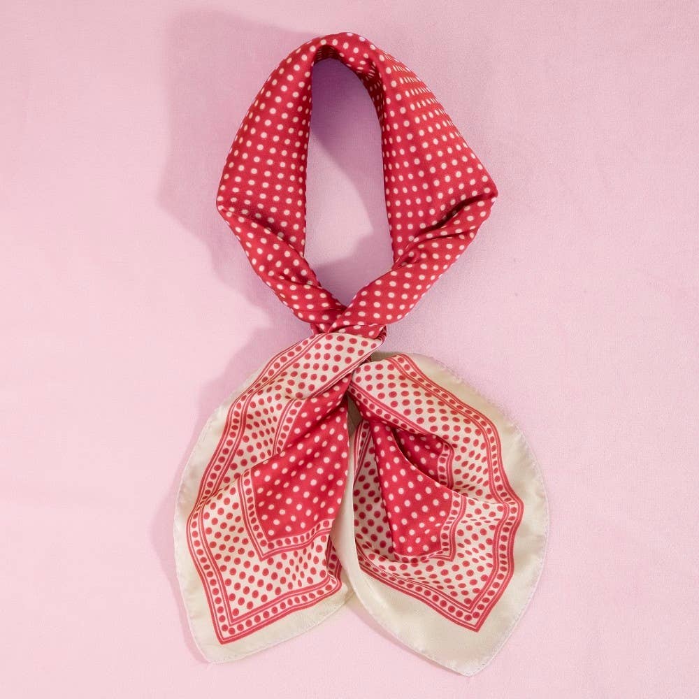 Red polka dot scarf on a pink background