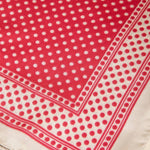 Red and white polka dot fabric with a border