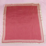 Red fabric with white polka dots on a pink background