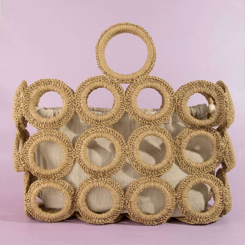 Woven basket with circular patterns on a pink background