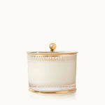 Decorative candle holder with gold accents on a white background