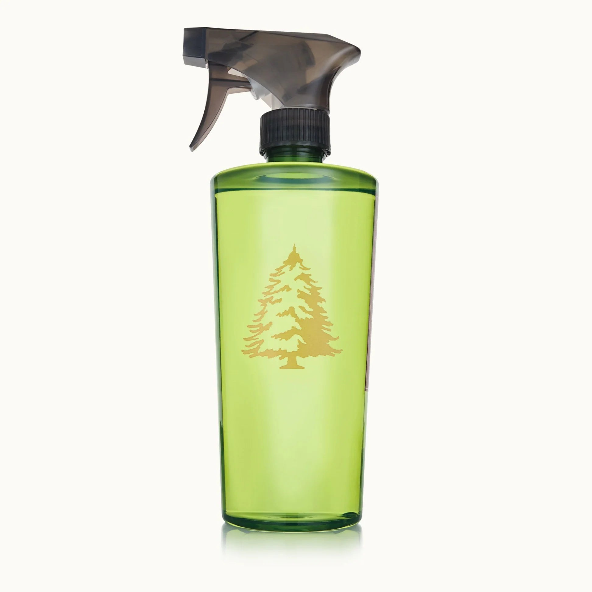 Green spray bottle with a black nozzle on a white background