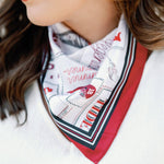 Woman wearing a patterned scarf with a white background